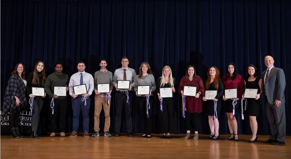 Group photo of the awardees for Academic Excellence in the Degree Program with Dr. Amy Campbell, Chair of the Graduate Council (far left) and Dr. Jeffrey Potteiger (far right). 